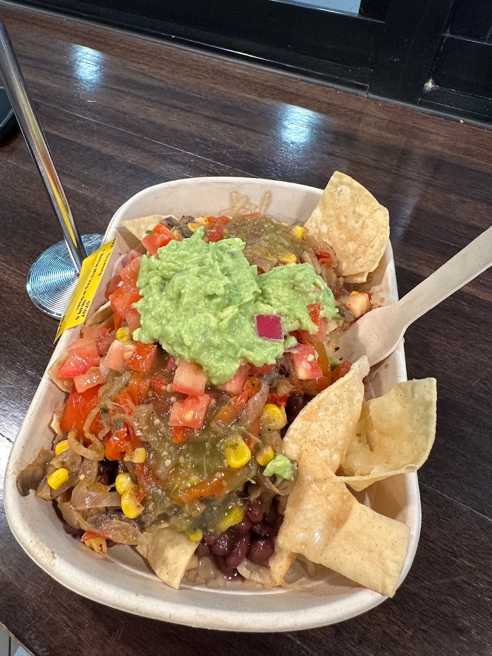 Loaded bowl with guacamole and corn chips at Guzman y Gomez Toowong Village