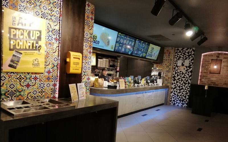 Order counter and menu boards at Guzman y Gomez Toowong Village